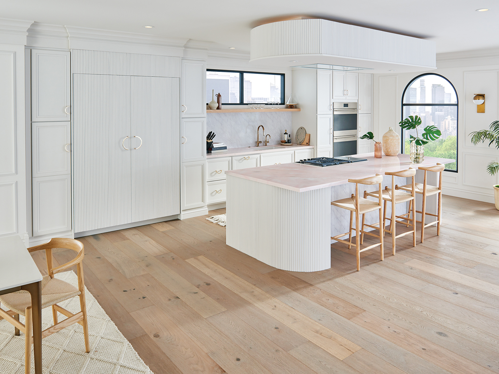 A bright white kitchen design remodeled with shaker and reeded cabinet doors.