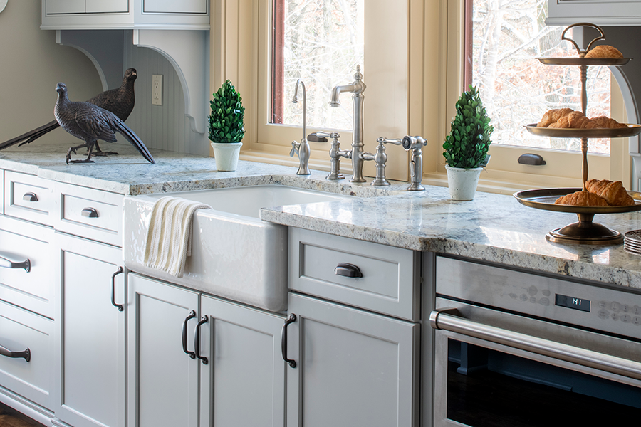 A traditional kitchen with American framed cabinets in a light gray painted finish.